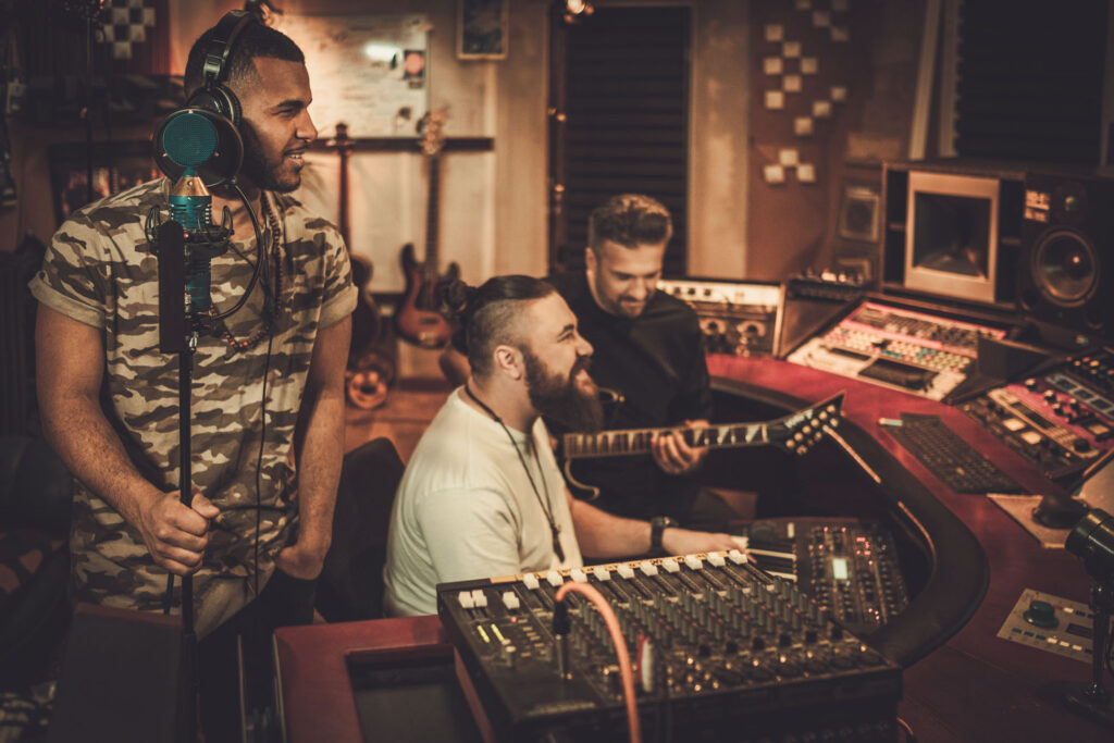 Professional music band recording song in boutique recording stu
