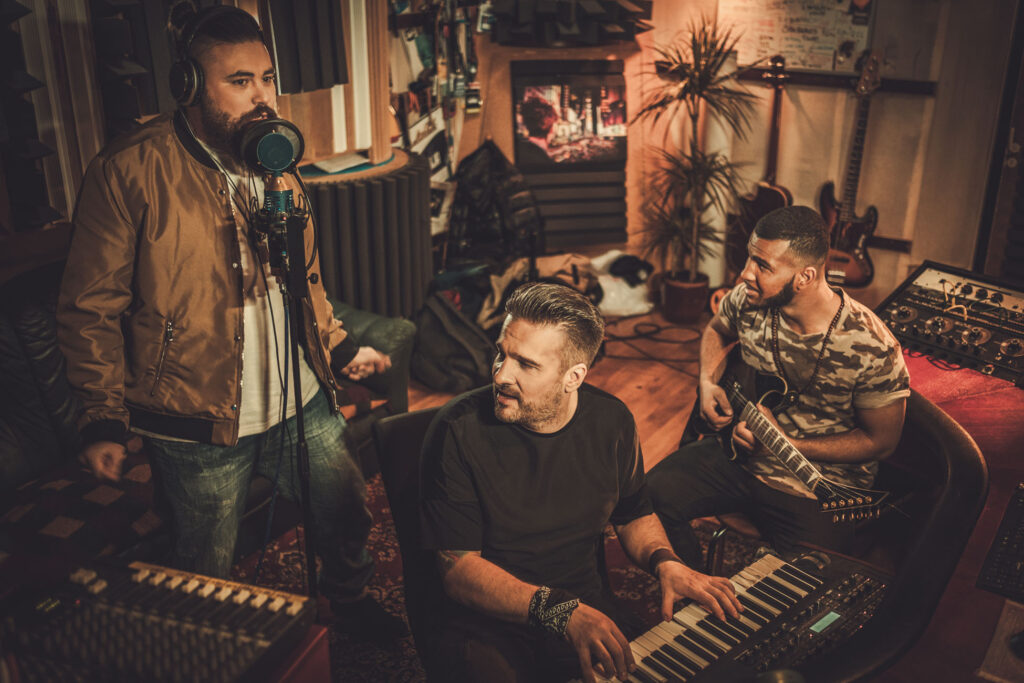 Professional music band recording song in boutique recording stu
